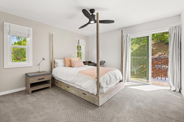 carpeted bedroom with baseboards, a ceiling fan, multiple windows, and access to exterior