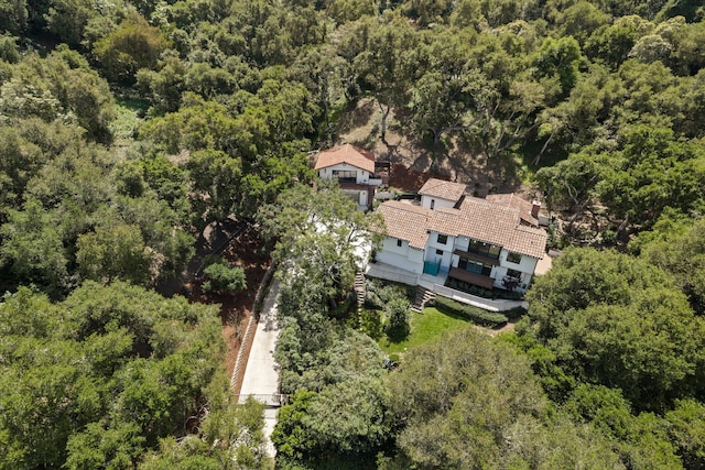 drone / aerial view with a wooded view