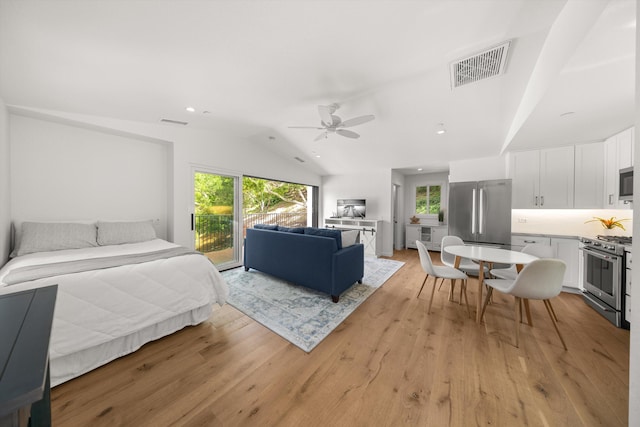bedroom with vaulted ceiling, light wood-style flooring, access to exterior, visible vents, and freestanding refrigerator