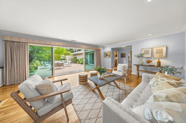 living room featuring crown molding, visible vents, baseboards, light wood-style floors, and recessed lighting