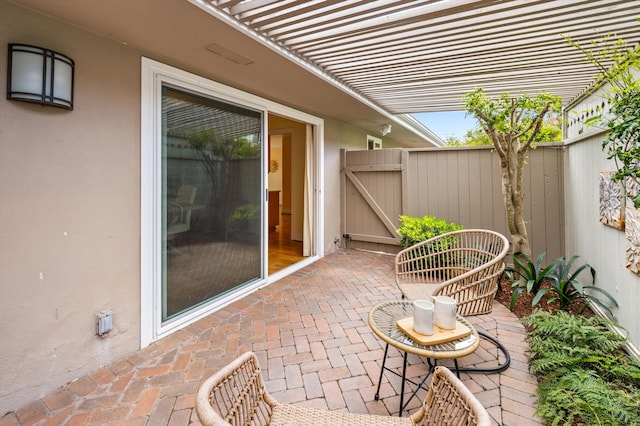 view of patio / terrace featuring fence and a gate