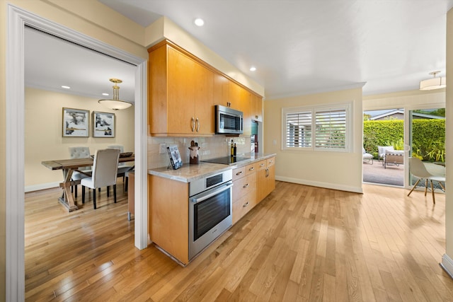 kitchen with appliances with stainless steel finishes, baseboards, backsplash, and light wood-style flooring