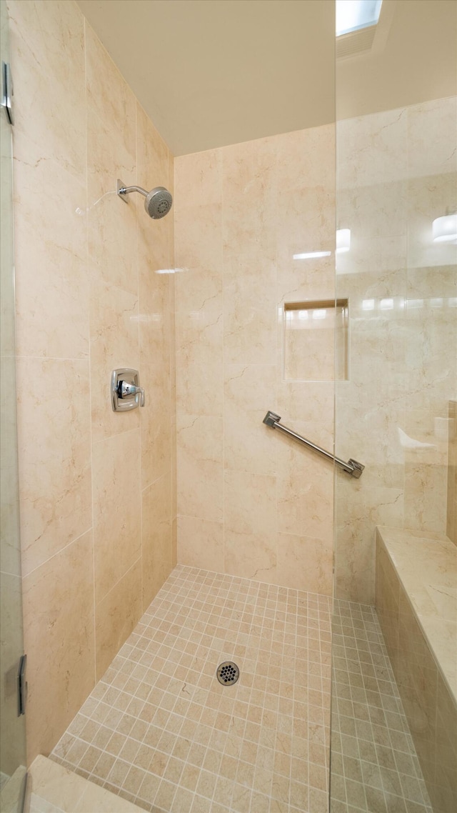 full bath with a tile shower