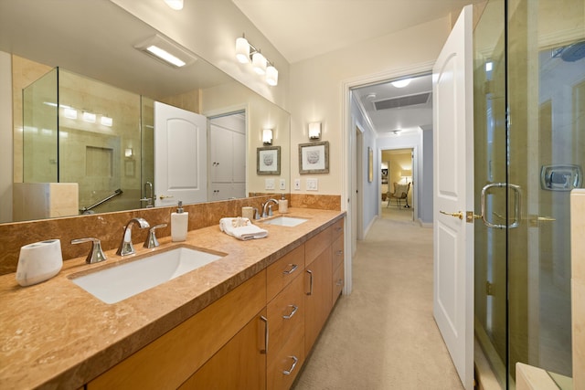 bathroom featuring connected bathroom, double vanity, a sink, and a stall shower