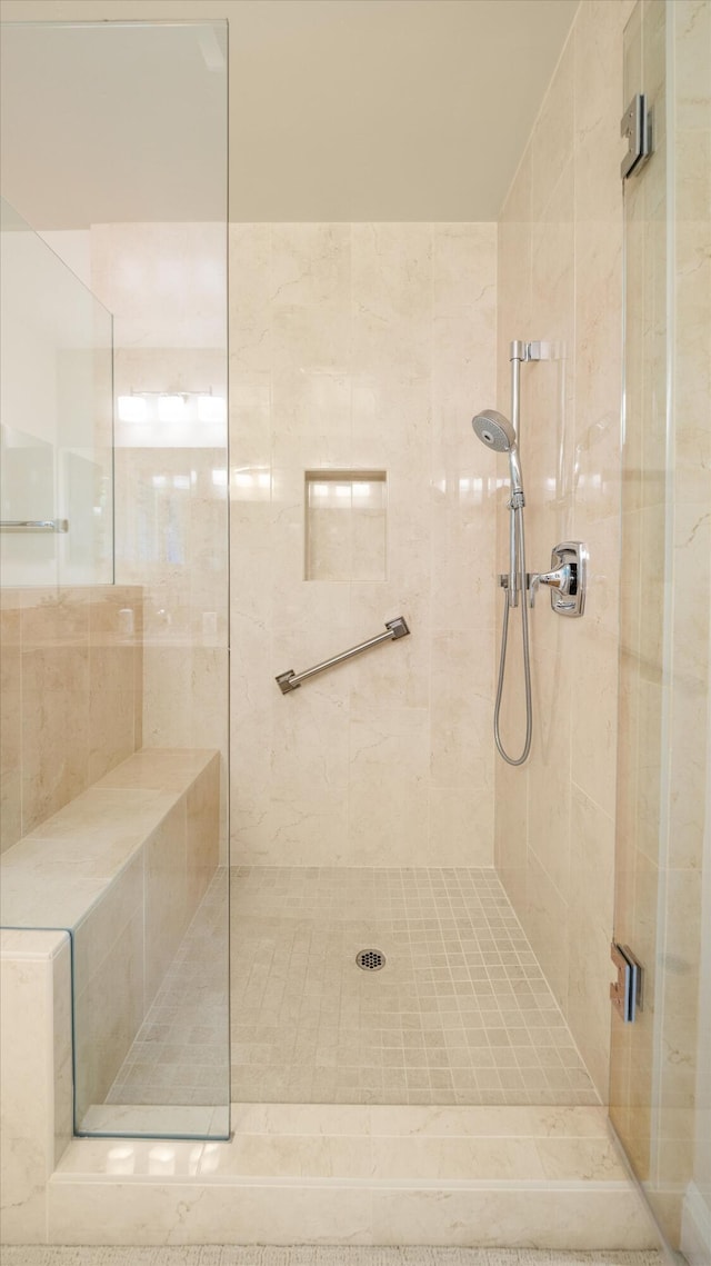 bathroom with a tile shower