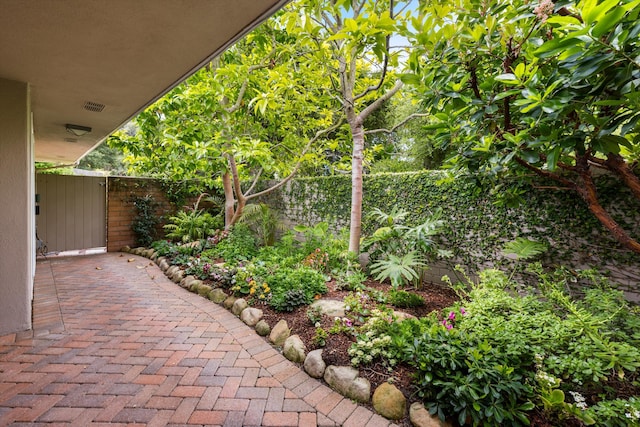 view of yard featuring fence and a gate