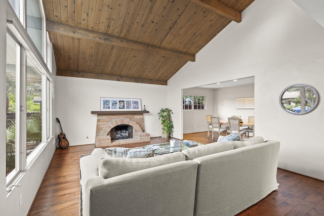living area with high vaulted ceiling, a fireplace with raised hearth, hardwood / wood-style flooring, beamed ceiling, and wooden ceiling