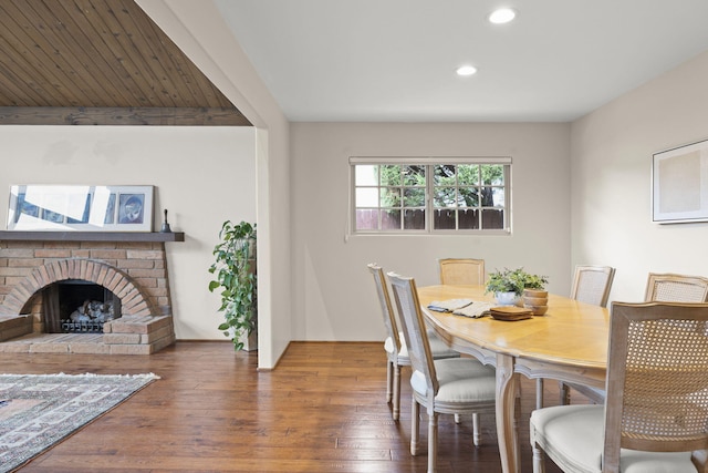 dining area featuring recessed lighting, wood finished floors, and a fireplace