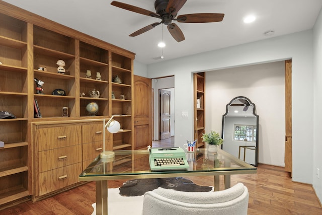 home office featuring a ceiling fan, visible vents, and light wood-style flooring