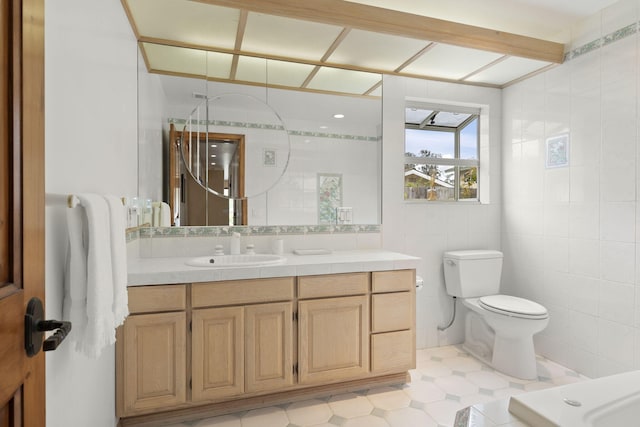 bathroom featuring tile walls, tile patterned floors, vanity, and toilet