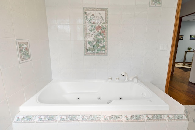 full bathroom with wood finished floors and a jetted tub