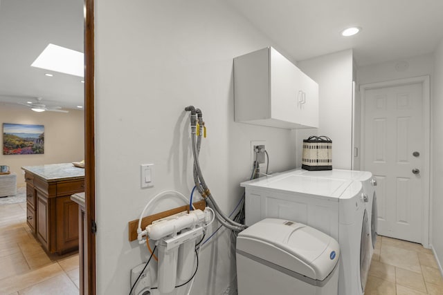 washroom featuring hookup for a washing machine, a skylight, light tile patterned floors, cabinet space, and recessed lighting