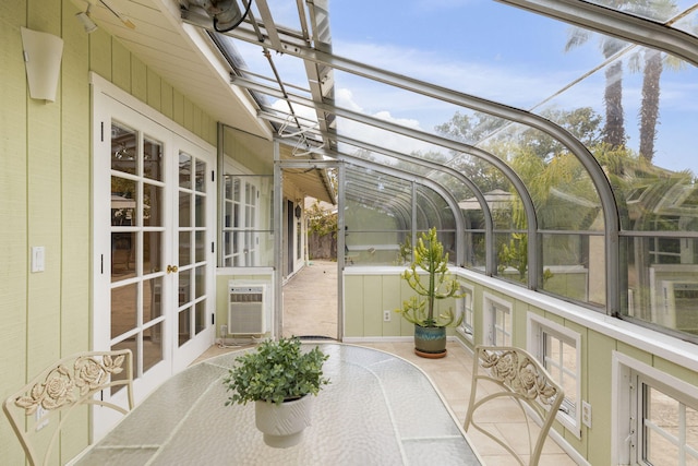 unfurnished sunroom with cooling unit, french doors, and outdoor dining space