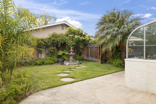 view of yard with a patio area and a fenced backyard