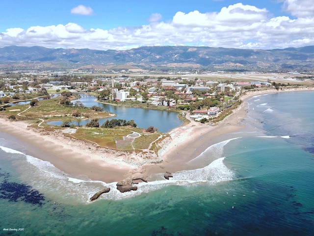 bird's eye view with a water and mountain view and a view of the beach
