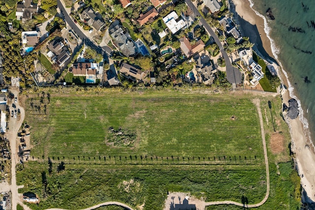 birds eye view of property with a beach view, a residential view, and a water view