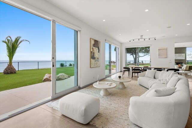 living area featuring recessed lighting and a water view
