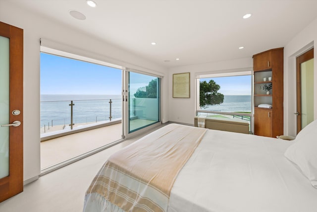 bedroom with recessed lighting, access to exterior, and a water view