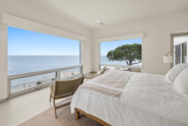 bedroom featuring recessed lighting and a water view