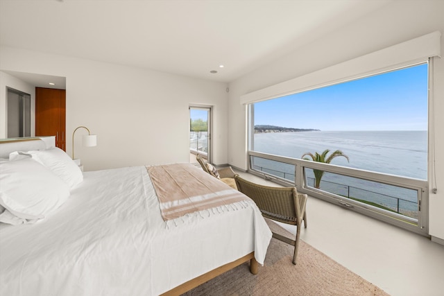 bedroom featuring recessed lighting and a water view