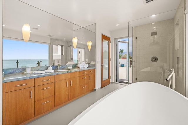 bathroom with a shower stall, a wealth of natural light, vanity, and visible vents