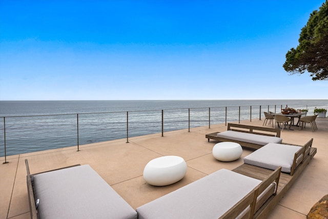 view of patio / terrace featuring outdoor dining space and a water view