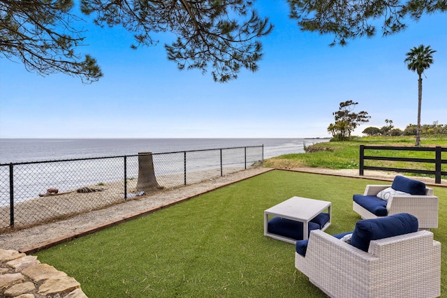 view of yard with fence and a water view