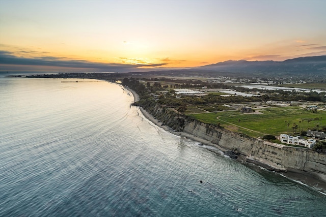aerial view at dusk with a water and mountain view