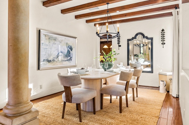 dining area with beamed ceiling, light wood-style flooring, visible vents, and a notable chandelier
