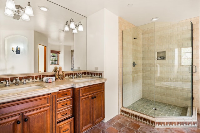 full bathroom featuring a shower stall, a sink, double vanity, and recessed lighting