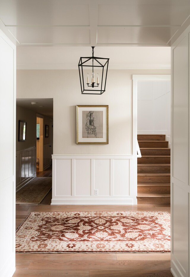 2749 Sycamore Canyon Rd, Santa Barbara, CA 93108 - interior space with a wainscoted wall, an inviting chandelier, wood finished floors, and a decorative wall