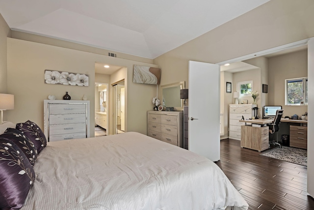 bedroom with ensuite bath, visible vents, vaulted ceiling, and dark wood-style flooring