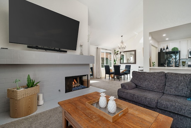 living area featuring high vaulted ceiling, a notable chandelier, and a multi sided fireplace