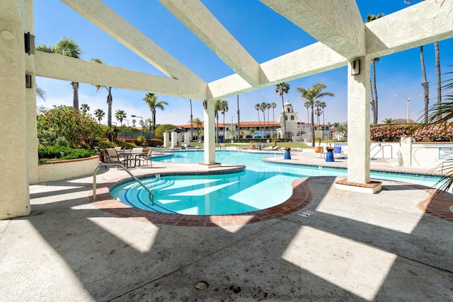 community pool with a patio area