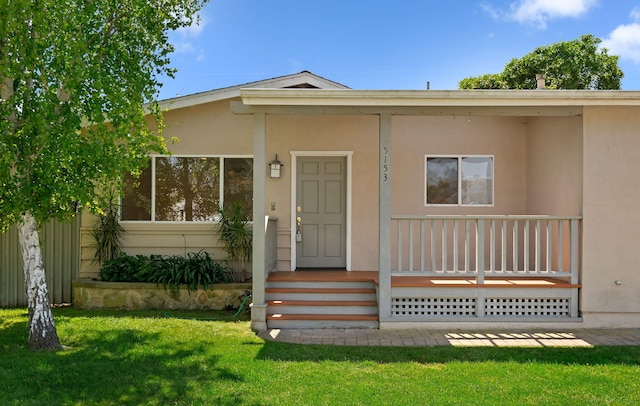 view of front of property with a front yard and stucco siding