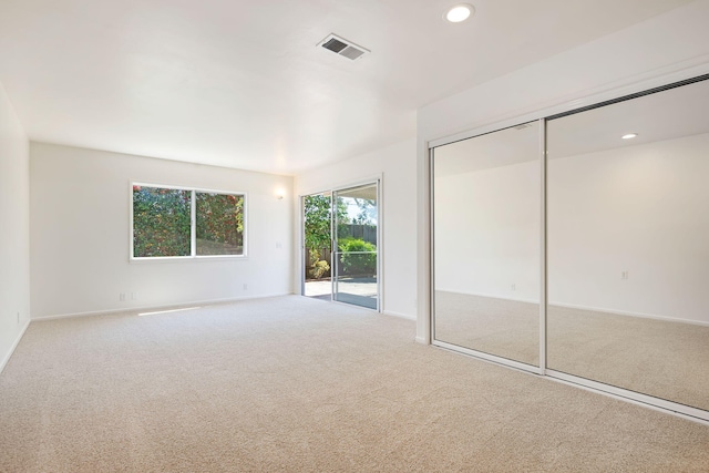 unfurnished bedroom featuring baseboards, access to outside, carpet flooring, visible vents, and recessed lighting