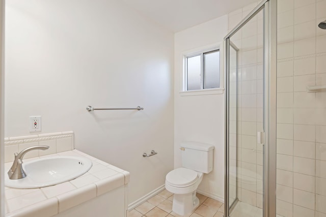 full bathroom with tile patterned floors, a sink, toilet, a stall shower, and baseboards