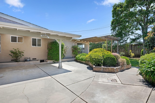 view of patio / terrace with a pergola and fence