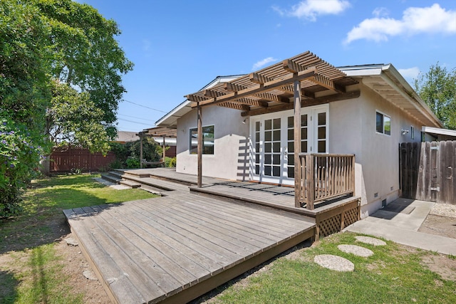 back of house with fence, a pergola, a wooden deck, and stucco siding