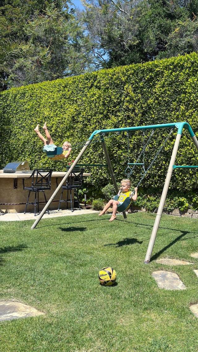 view of jungle gym with a lawn
