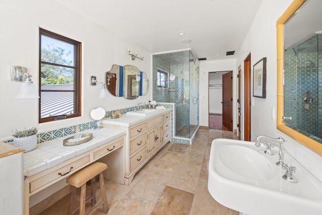 full bathroom featuring visible vents, a sink, and a stall shower
