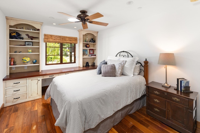 bedroom with ceiling fan, recessed lighting, built in desk, and wood finished floors