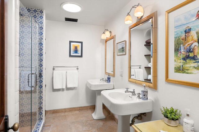 full bathroom featuring visible vents, baseboards, tile patterned floors, and a shower stall