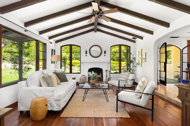sunroom / solarium featuring arched walkways and beamed ceiling