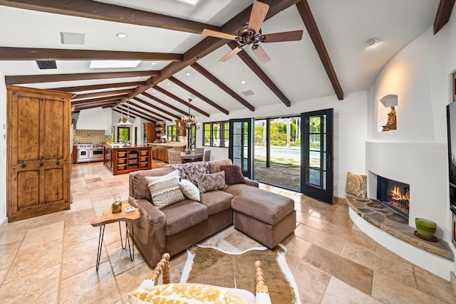 living area with a fireplace, lofted ceiling with beams, ceiling fan with notable chandelier, stone tile flooring, and recessed lighting