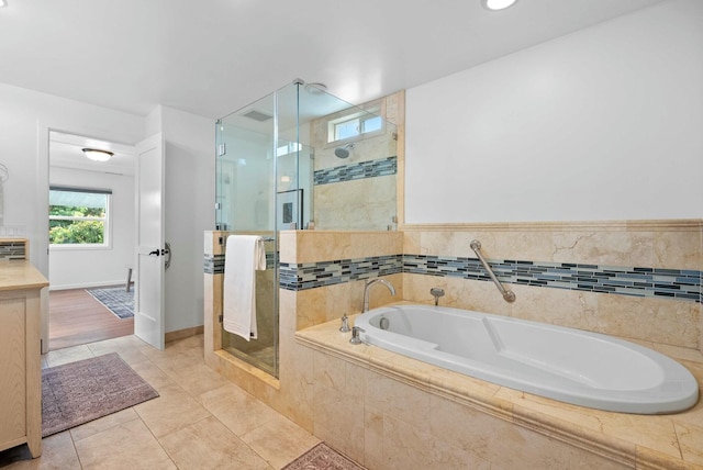bathroom with a bath, tile patterned floors, visible vents, a shower stall, and vanity