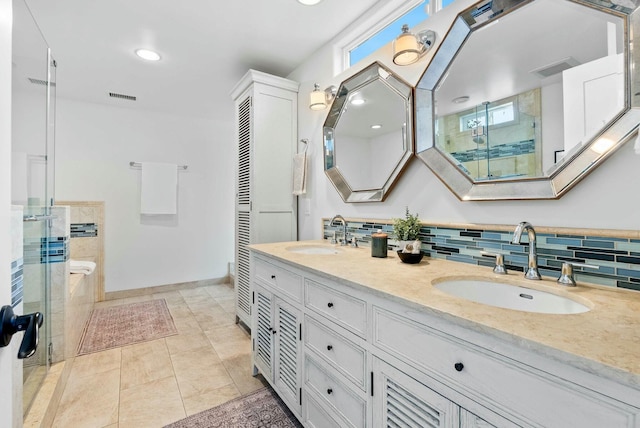 full bathroom with double vanity, visible vents, a stall shower, and a sink