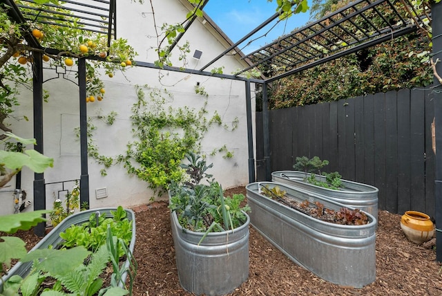 exterior space featuring a garden and fence