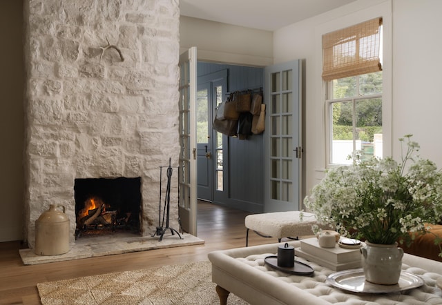 living area with a fireplace and wood finished floors