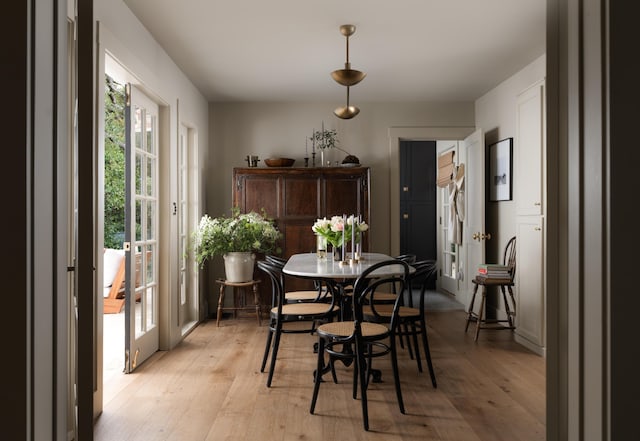 dining space featuring light wood finished floors